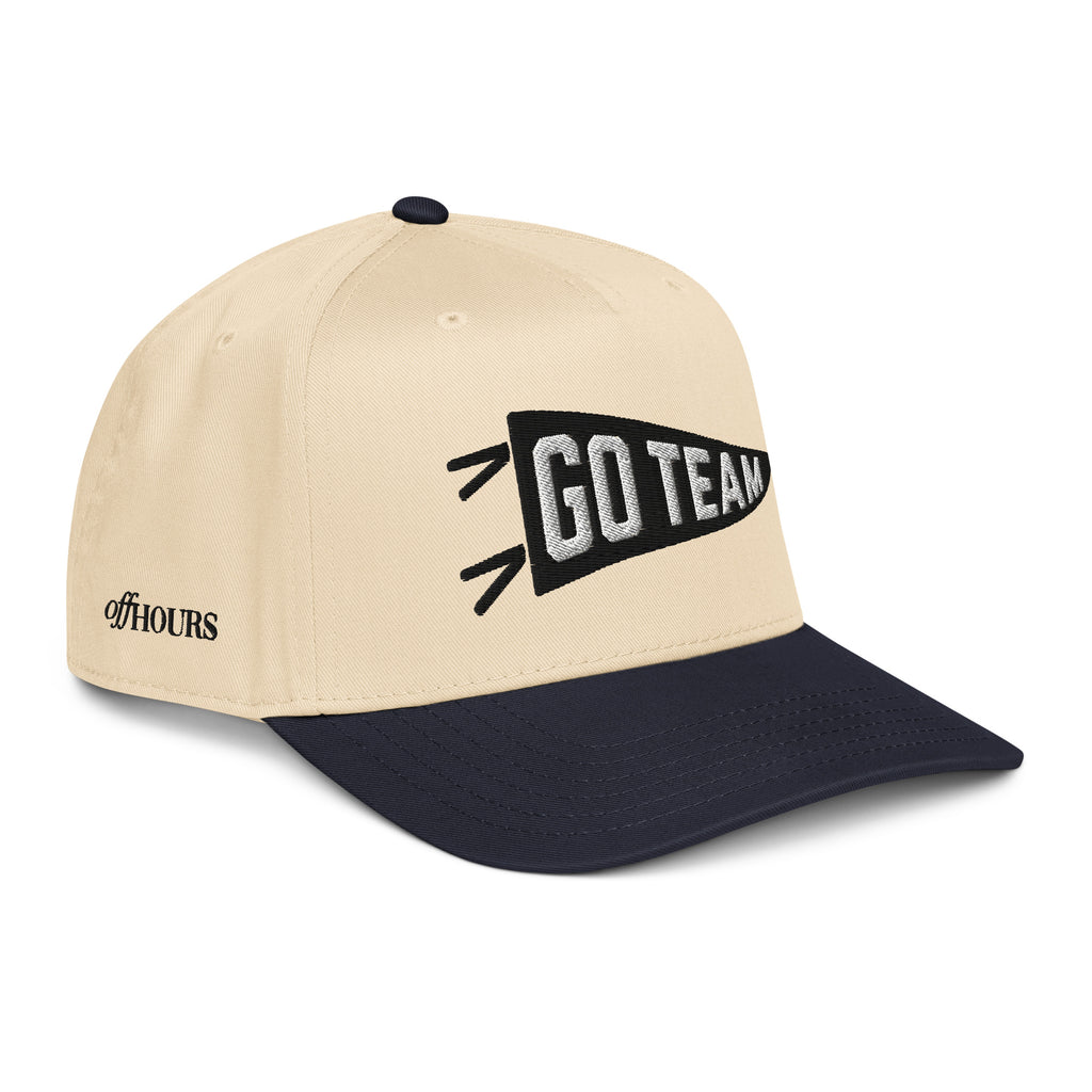 Angled view of Go Team navy and natural trucker hat by Off Hours