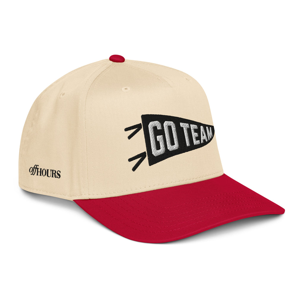 Angled view of Go Team red and natural trucker hat by Off Hours