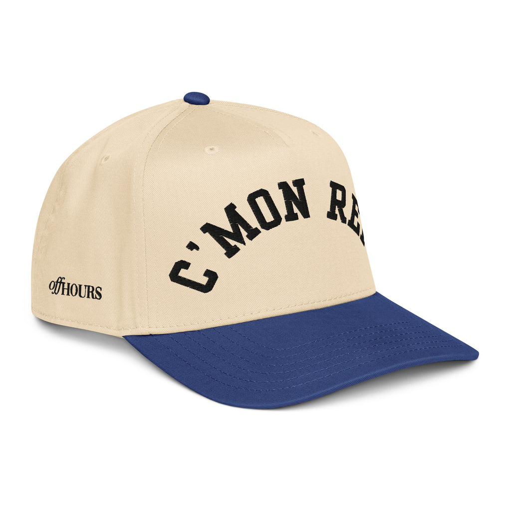 Angled view of C'MON REF! blue and natural trucker hat by Off Hours