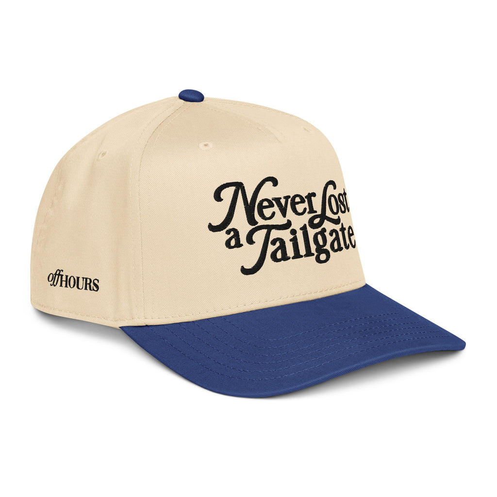 Angled view of Never Lost a Tailgate blue and natural trucker hat by Off Hours