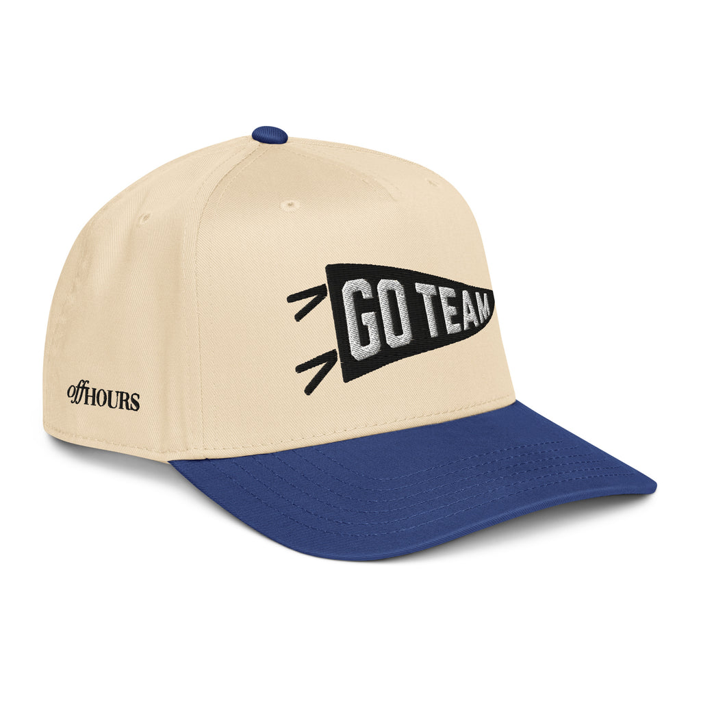Angled view of Go Team blue and natural trucker hat by Off Hours